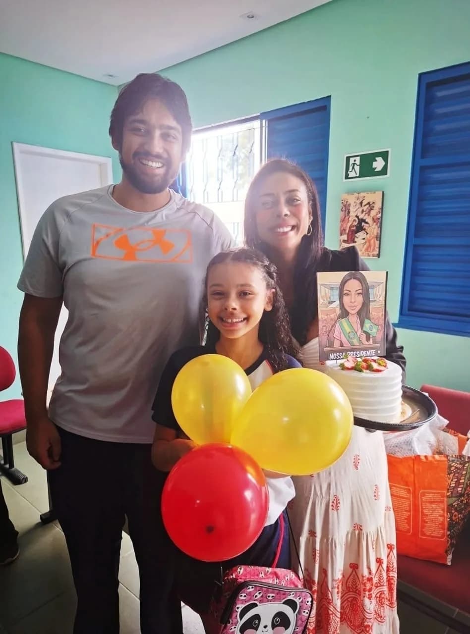 Liziene Rodrigues com a equipe e o bolo de aniversário