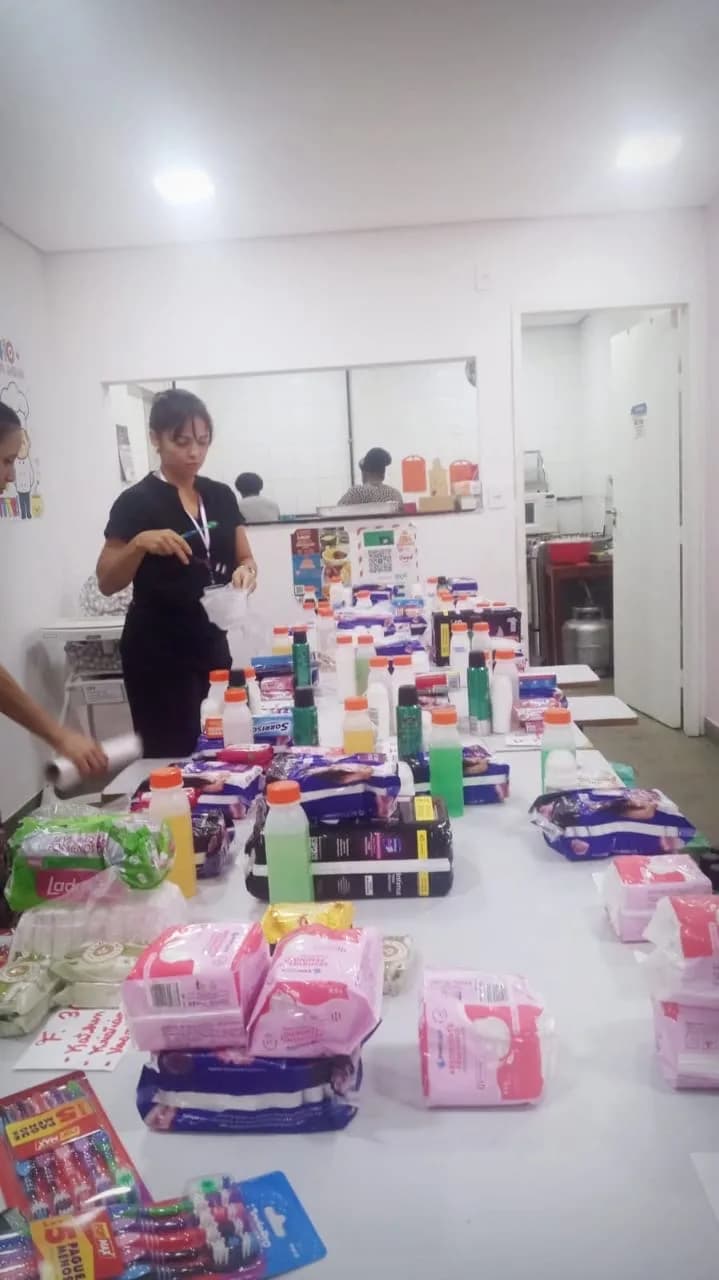 Voluntária organizando itens de higiene na mesa de separação